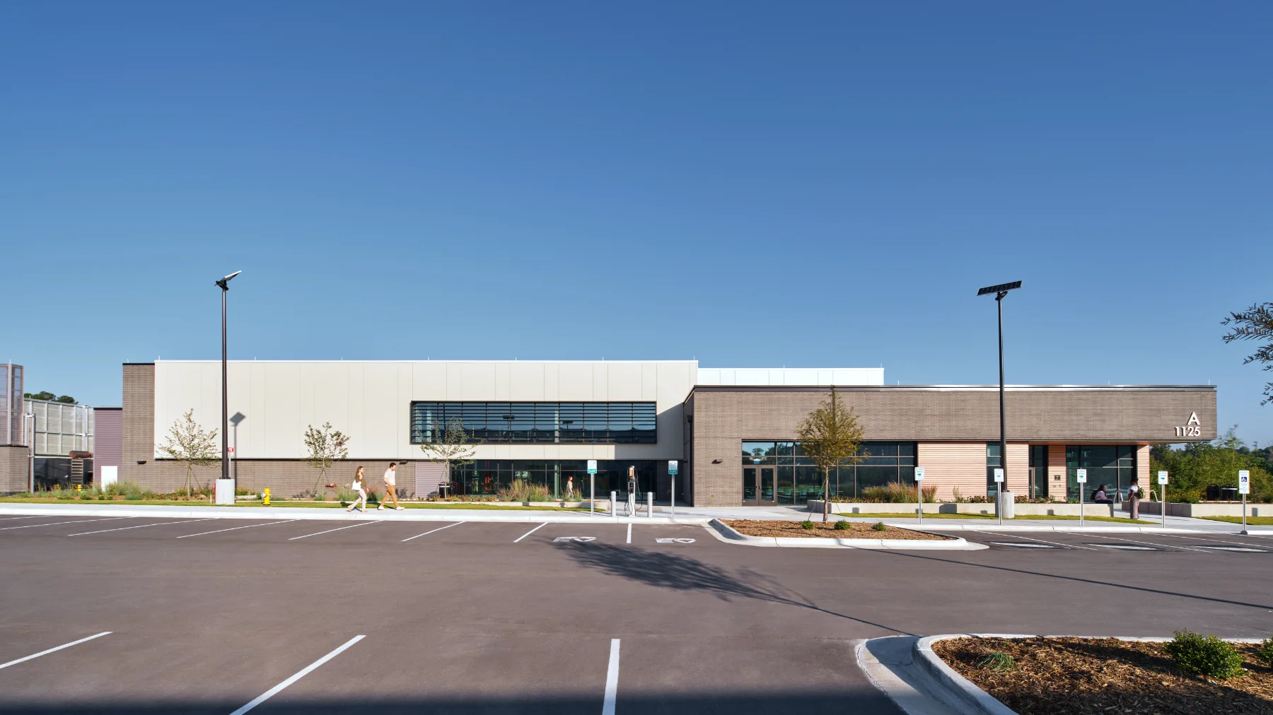 The parking lot and exterior of the Central Energy Plant by HH Architecture