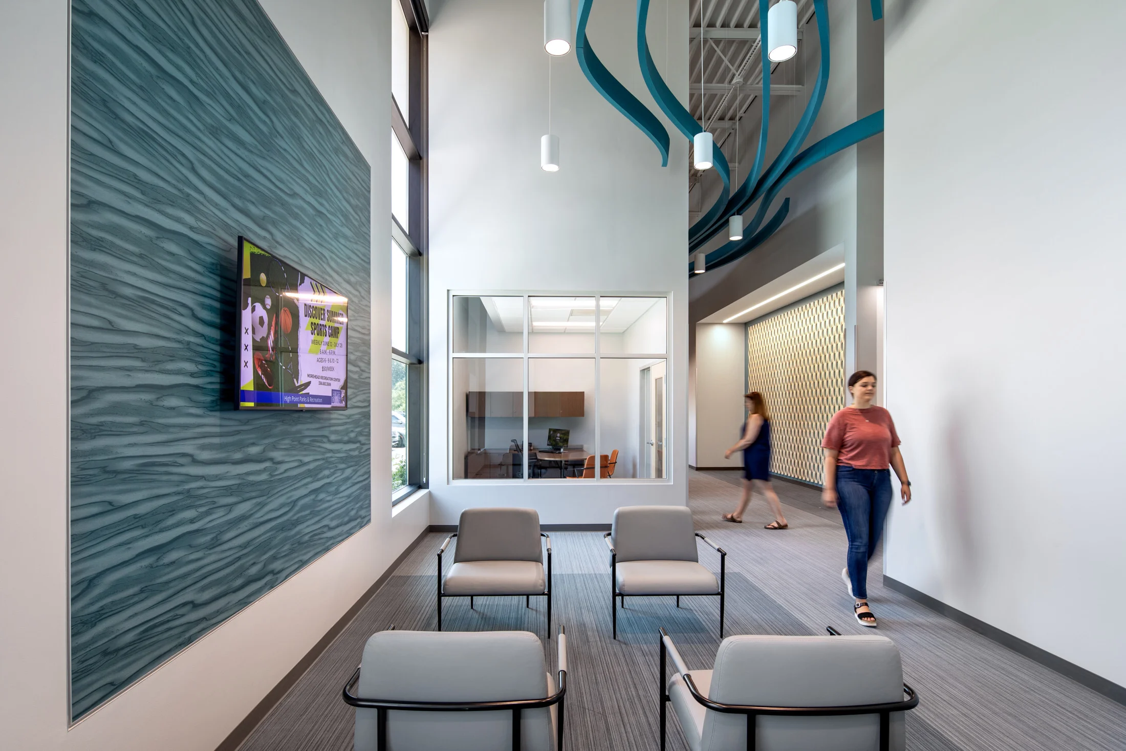 A hallway and lobby area inside of the Central Energy Plant by HH Architecture