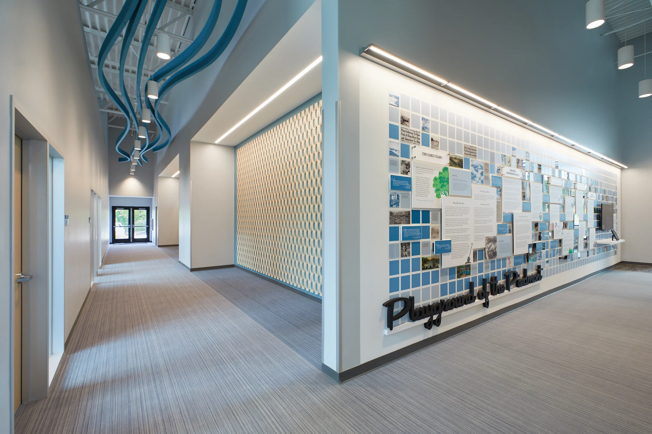 A hallway and history wall inside of the Central Energy Plant by HH Architecture